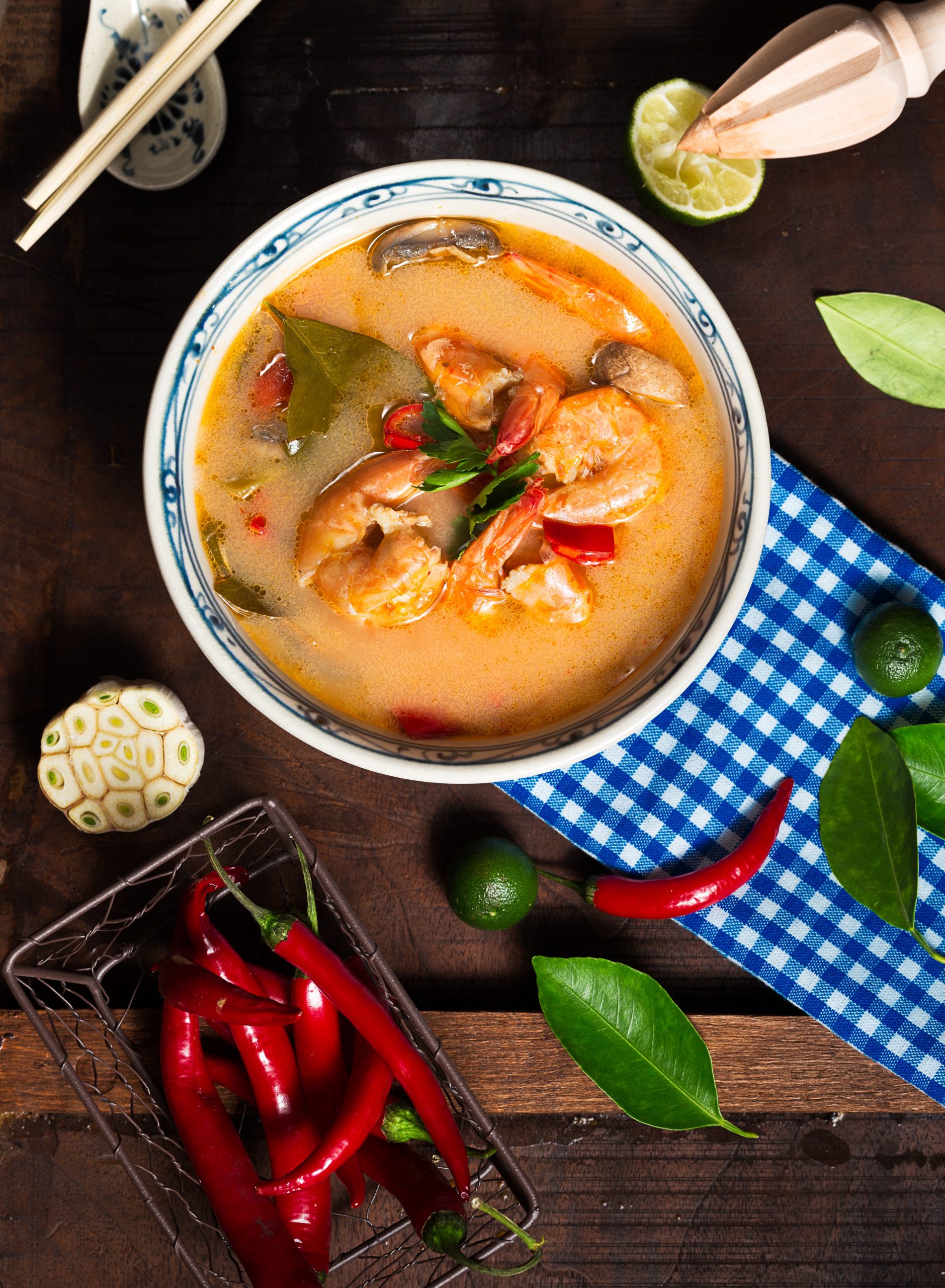 shrimp-soup-in-white-ceramic-bowl-with-chili-on-brown-wooden-1437590